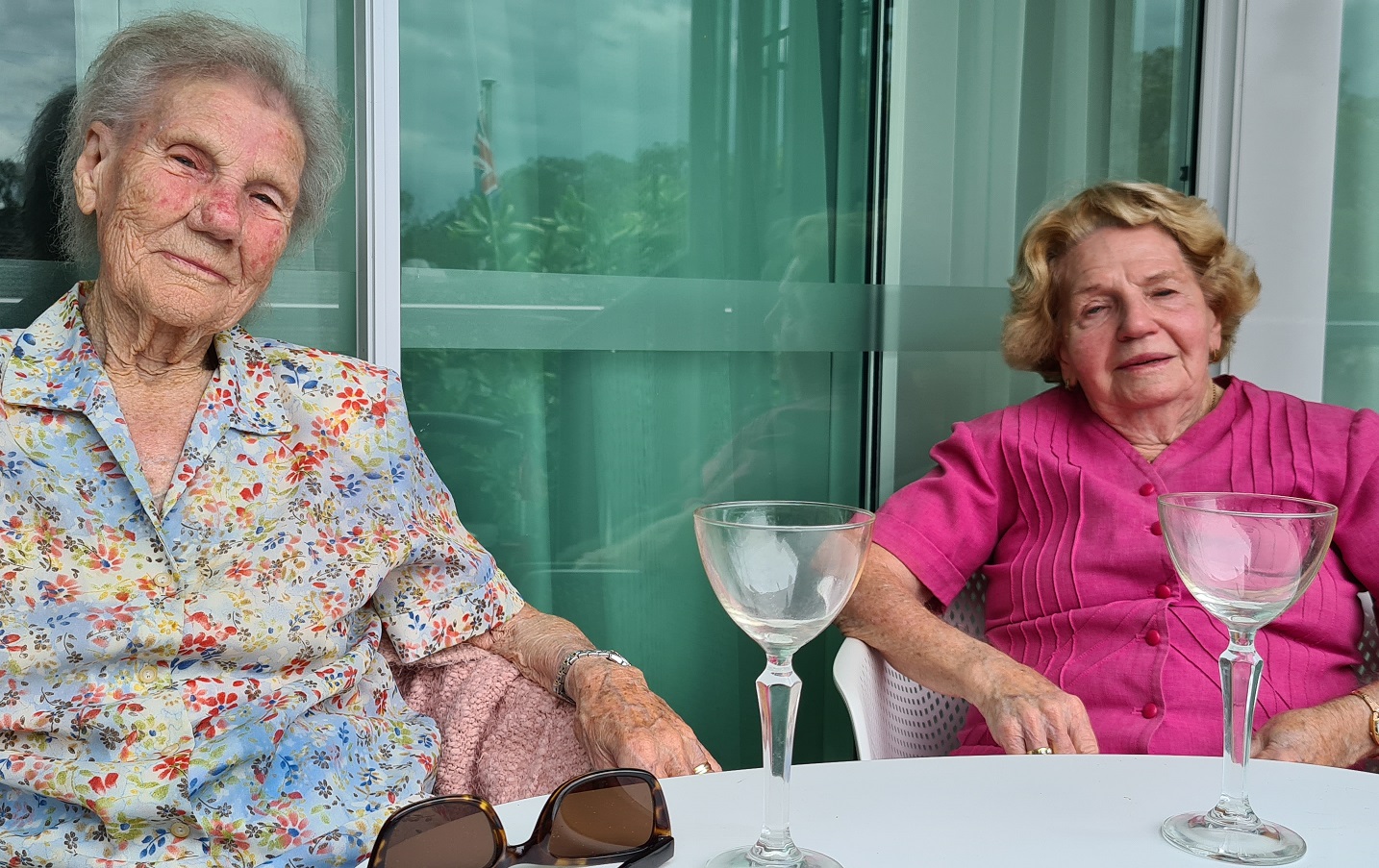 aged care residents having a drink together on balcony
